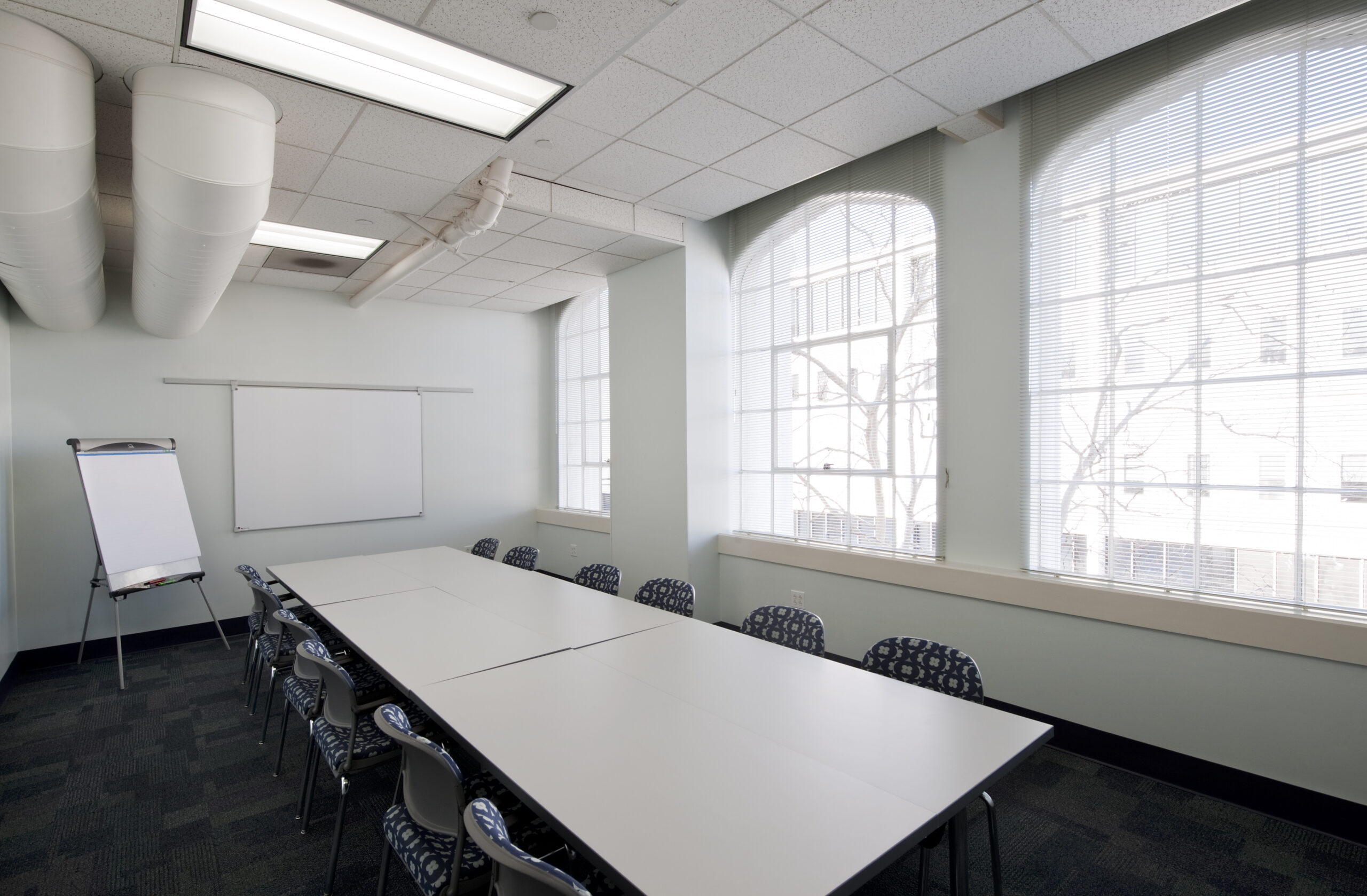 The TEC Albany Room is setup in a conference style layout for 12.